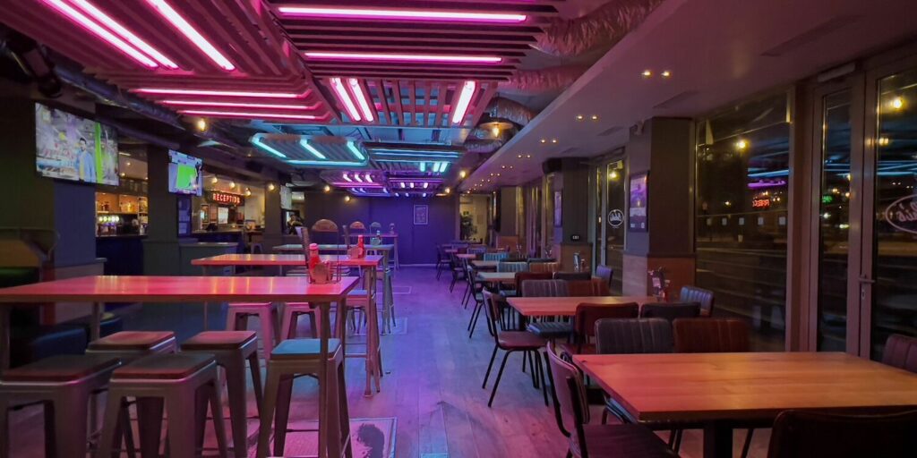 An interior shot of neon lights in Belushi's bar in Paris Canal.