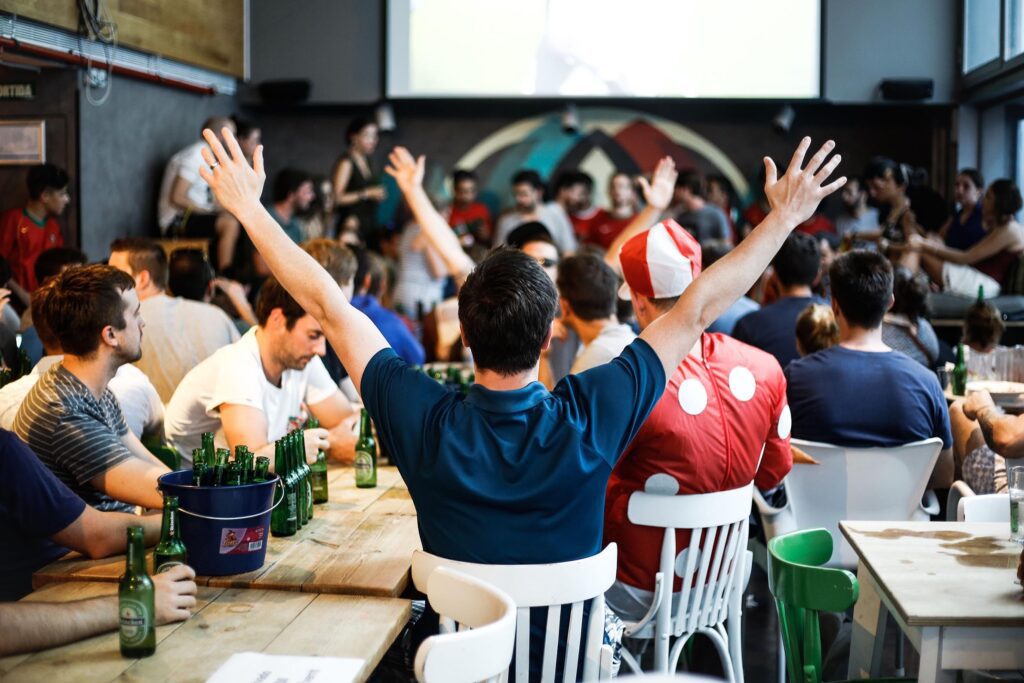 Sports fans enjoy a football match on an HD projector in Belushi's bar in Barcelona.