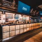 A long, modern bar in Belushi's bar in London Bridge.