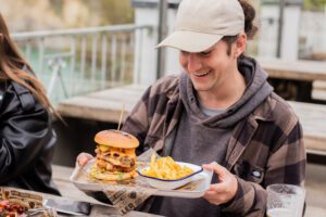 A man enjoys a burger at Belushi's bar in Newquay.