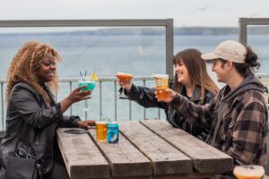 A group of friends enjoy a cocktail on the terrace of Belushi's bar in Newquay.