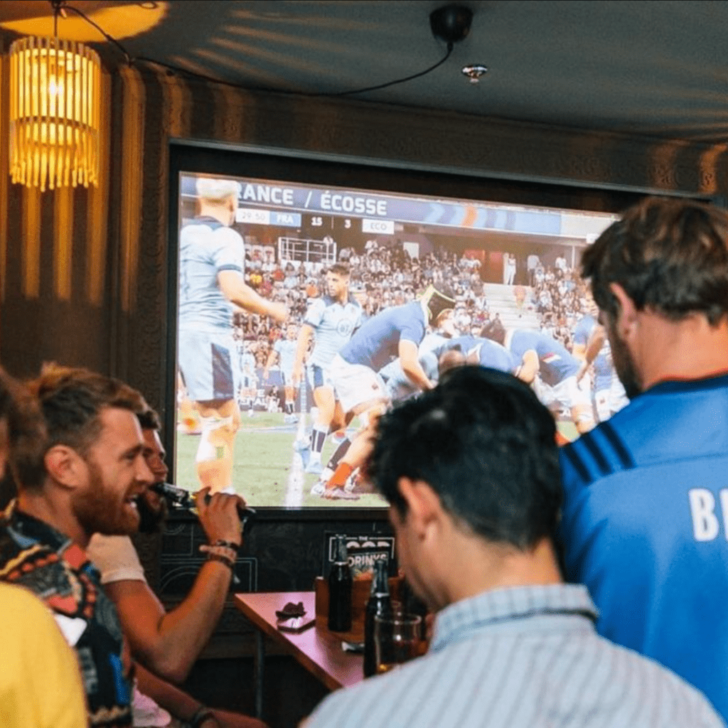 Friends watch sport on a big screen at Belushi's bar in Berlin Mitte.