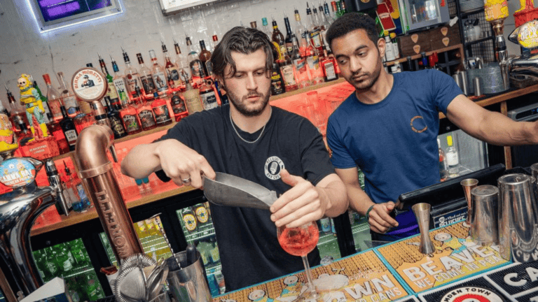 A bartender pours a drink in Belushi's Camden.