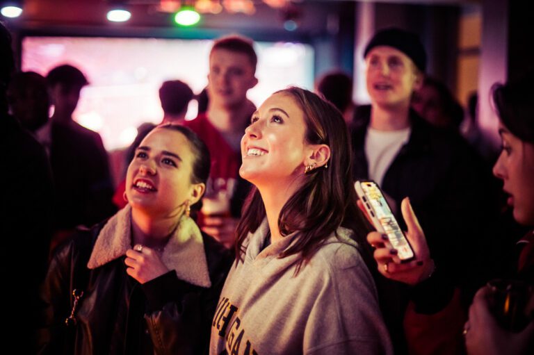 Female fans watch NFL at Belushi's Bars.