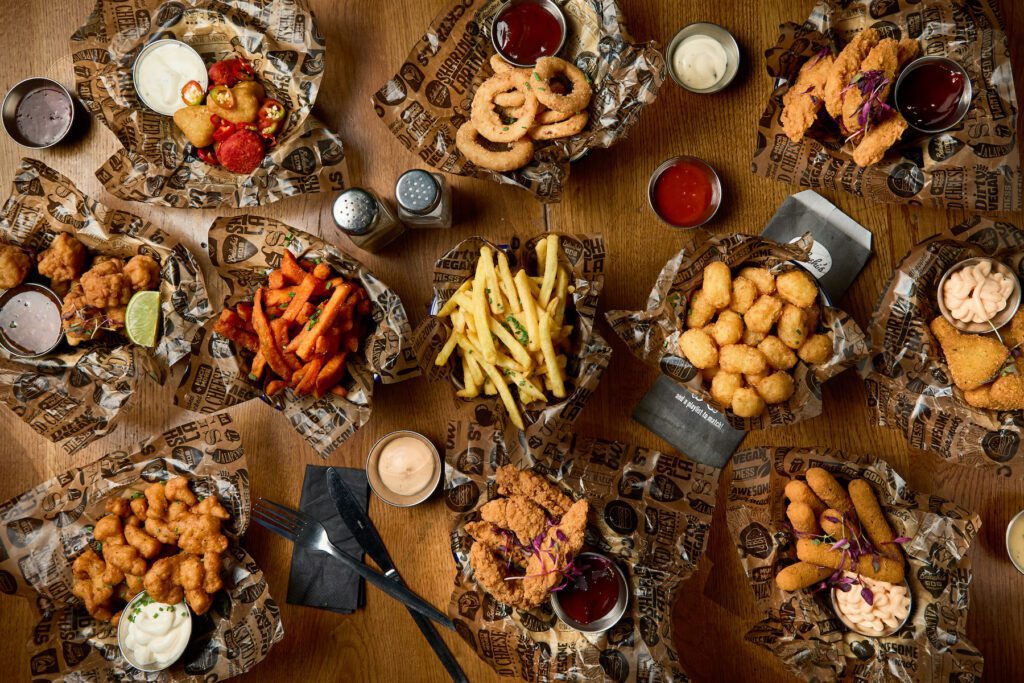 Small plates of pub food, covering a table.