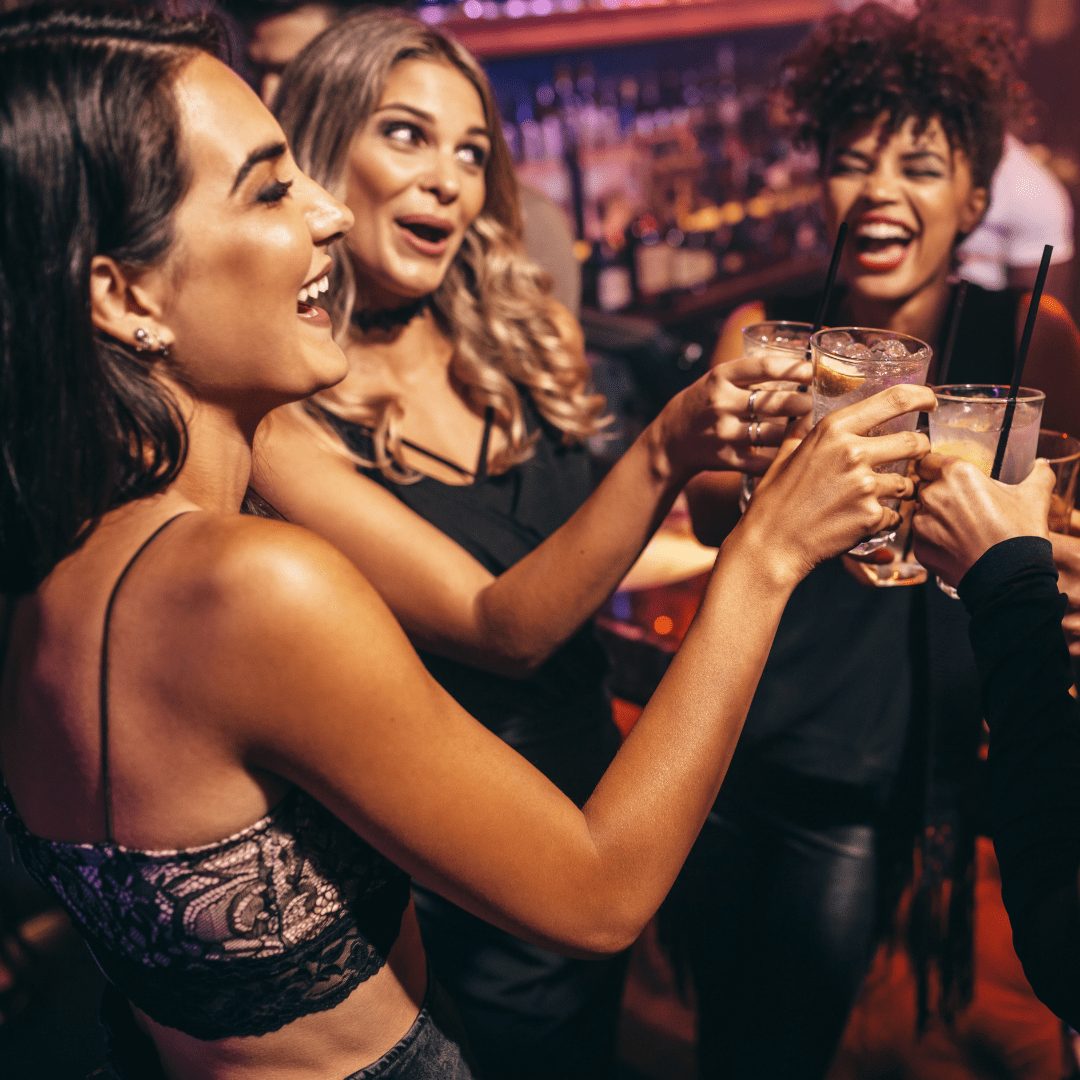 A group of young people enjoy a drink in a bar.