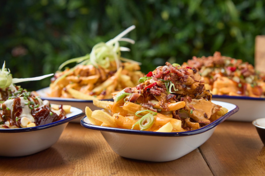 Plates of loaded fries in a Belushi's Bar.