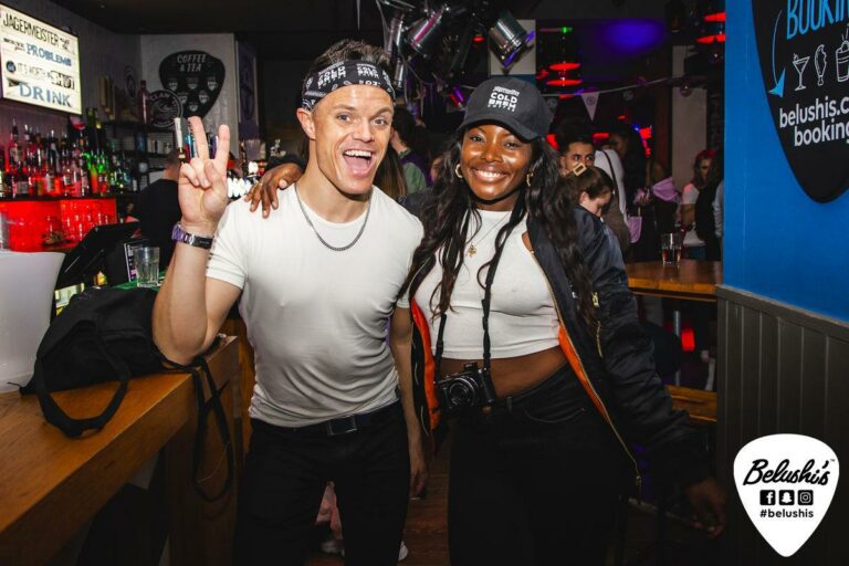 Two bartenders at a Belushi's Bar on Halloween.