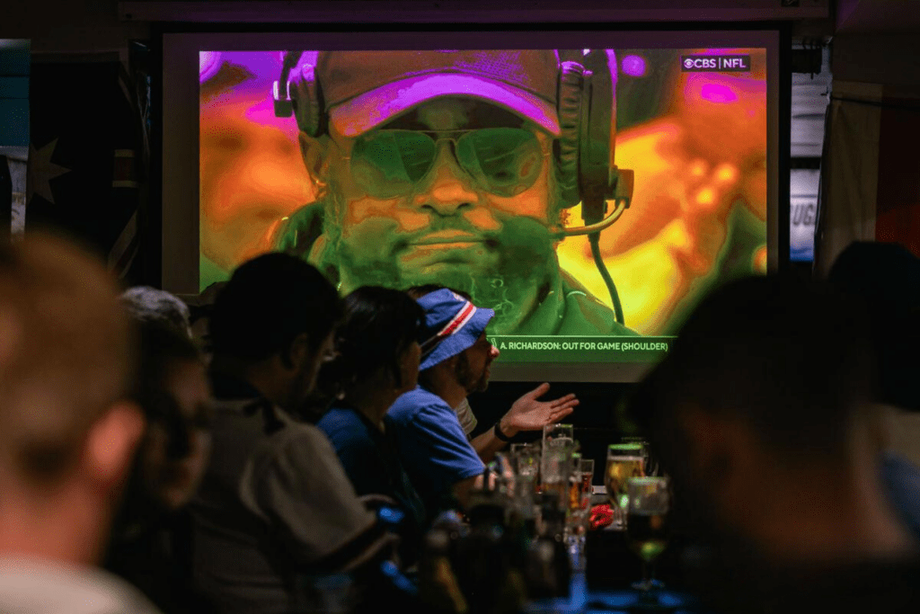 A view of a big screen with NFL at a Belushi's bar.