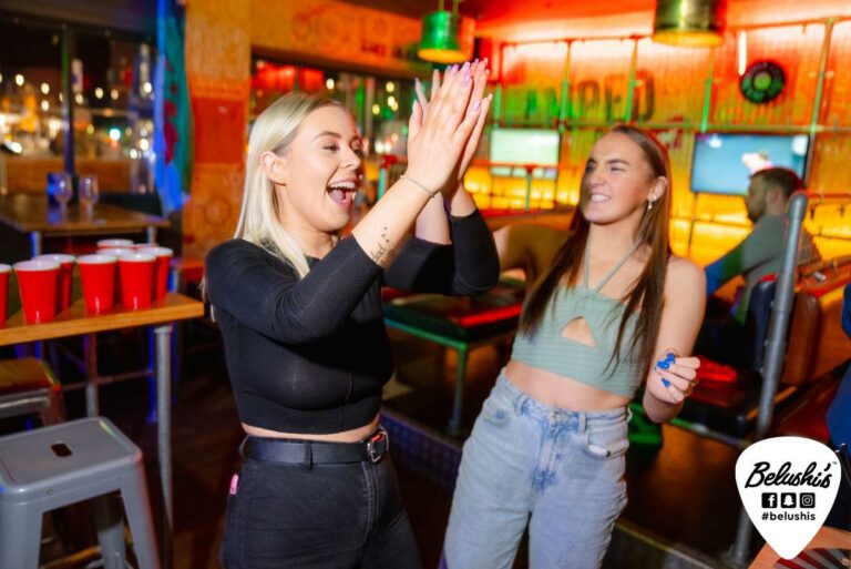 Two friends dance and applaud in Shepherd's Bush Belushi's.