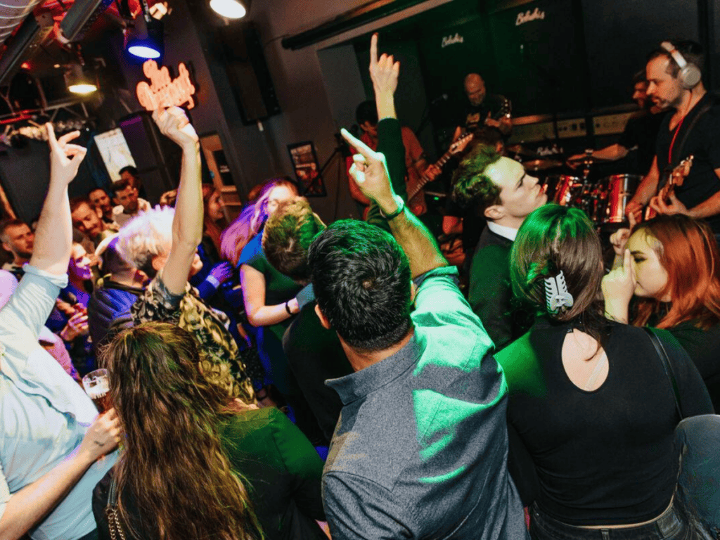 Groups dancing in a Belushi's Bar.