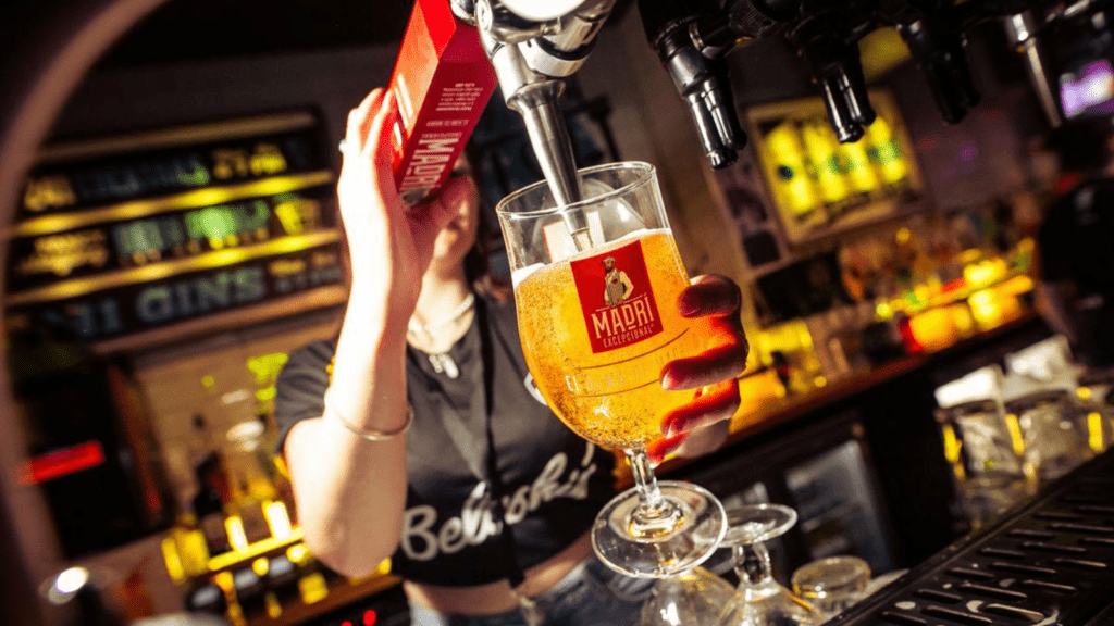 A bartender pours a pint in a Belushi's Bar.