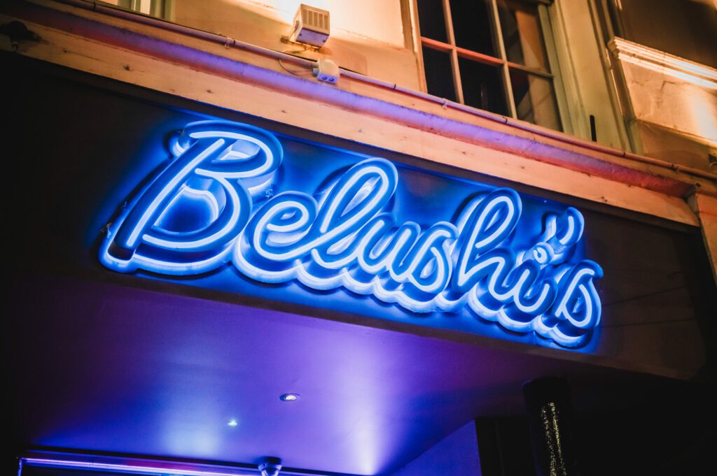 Belushi's neon sign outside of the venue.