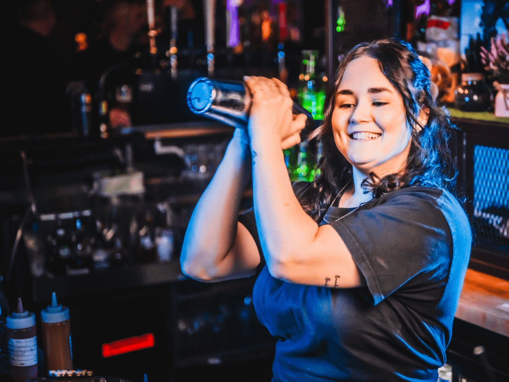 A bartender shakes a Margarita at a Belushi's Bar.