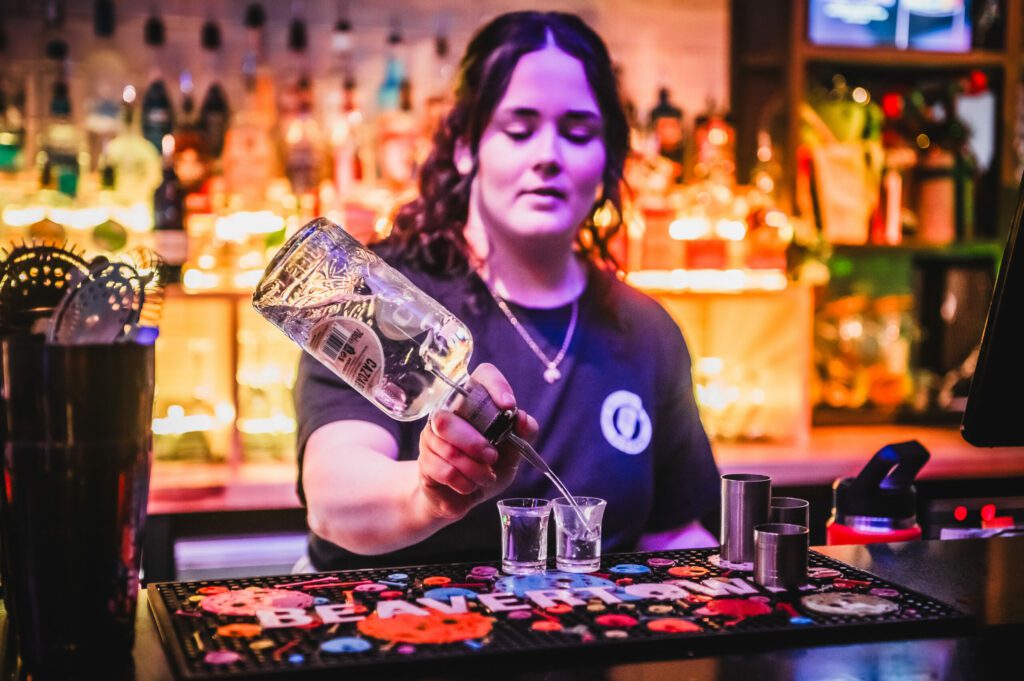 A bartender pours shots of Cazcabel tequila in a Belushi's Bar.