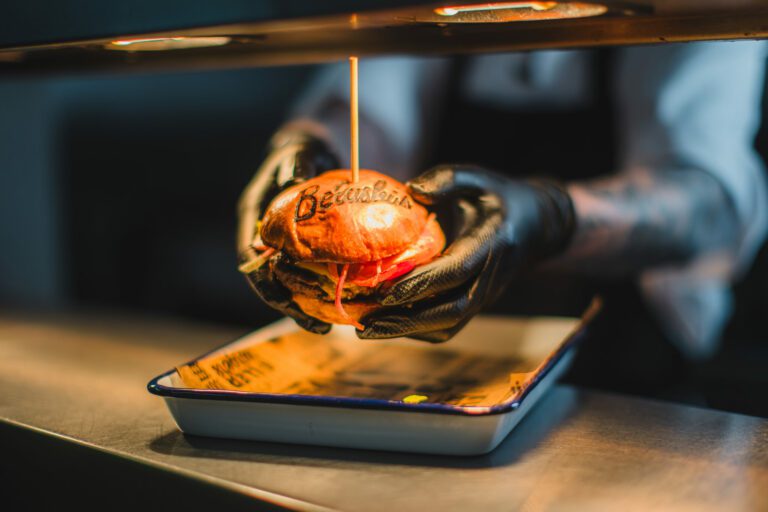 A chef serves up a delicious burger at Belushi's Bar in Hammersmith.