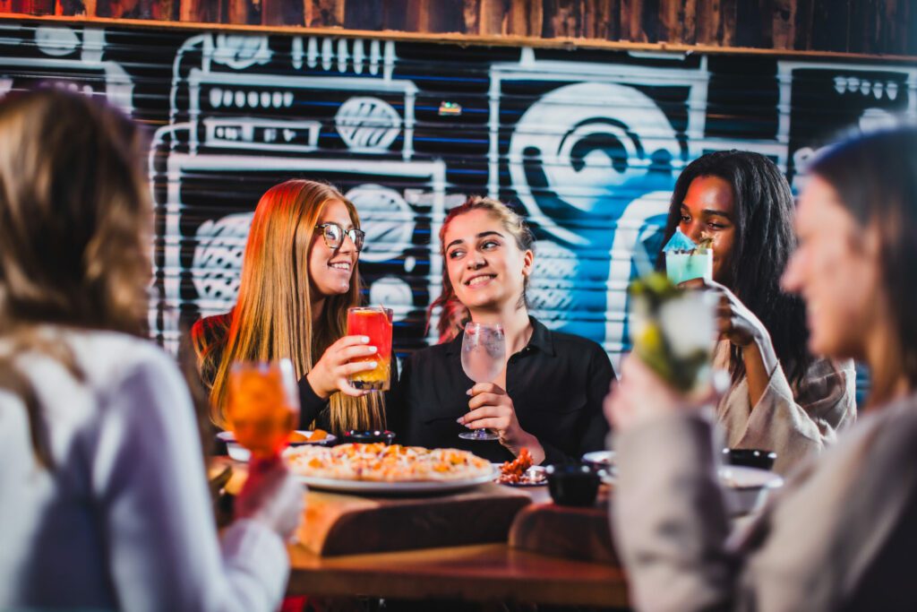 Friends enjoy food and drink in Belushi's Bar in Hammersmith.