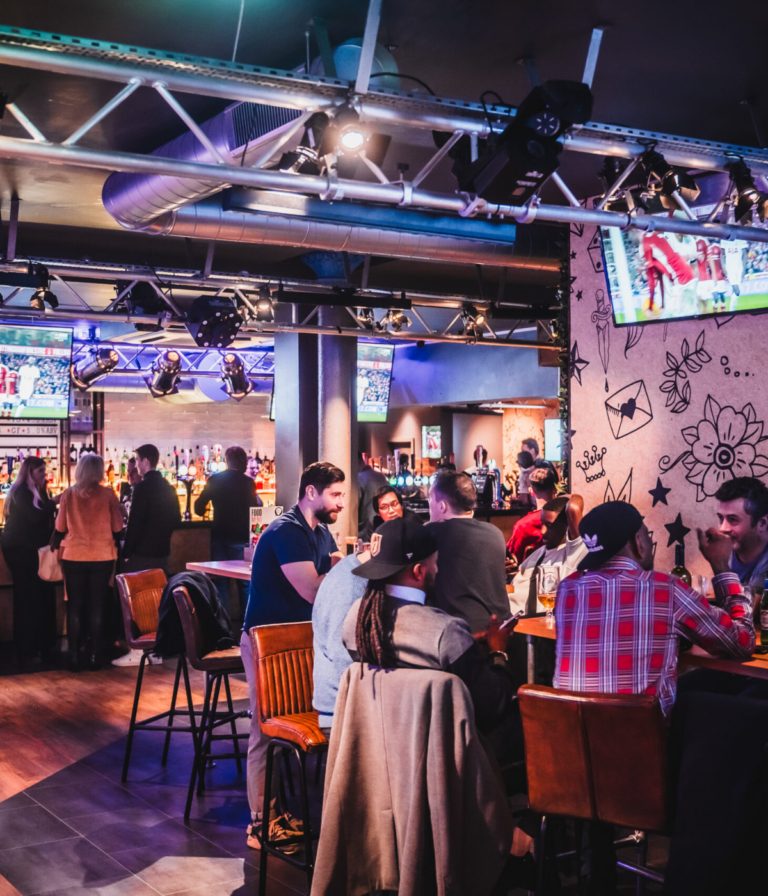 People watch the Premier League final day on huge screens in a Belushi's Bar.