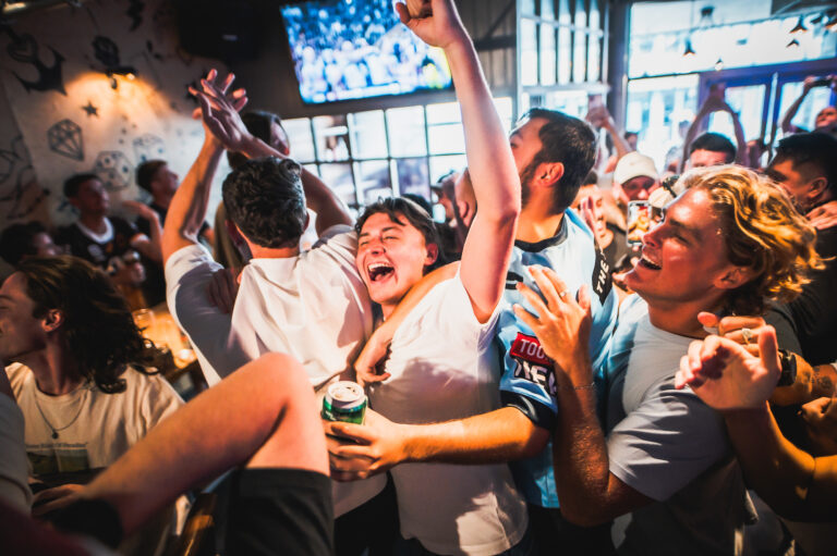 Aussie fans celebrating the AFL in Belushi's Bar.