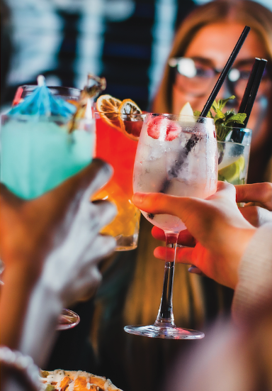 A close-up image of 4 colourful cocktails brought together in a 