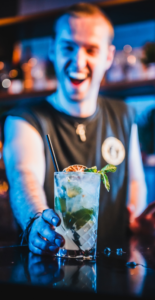 Picture of a bartender serving a mojito