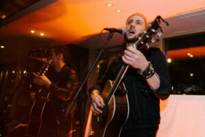 A live musician performing at a Belushi's bar