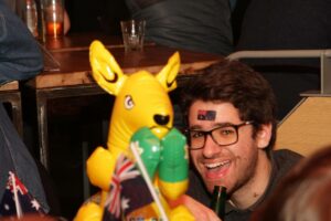 An image of a man with an Australian flag stamped on his forehead and an inflatable kangaroo