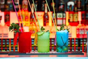 A zoomed in picture of three colourful cocktails