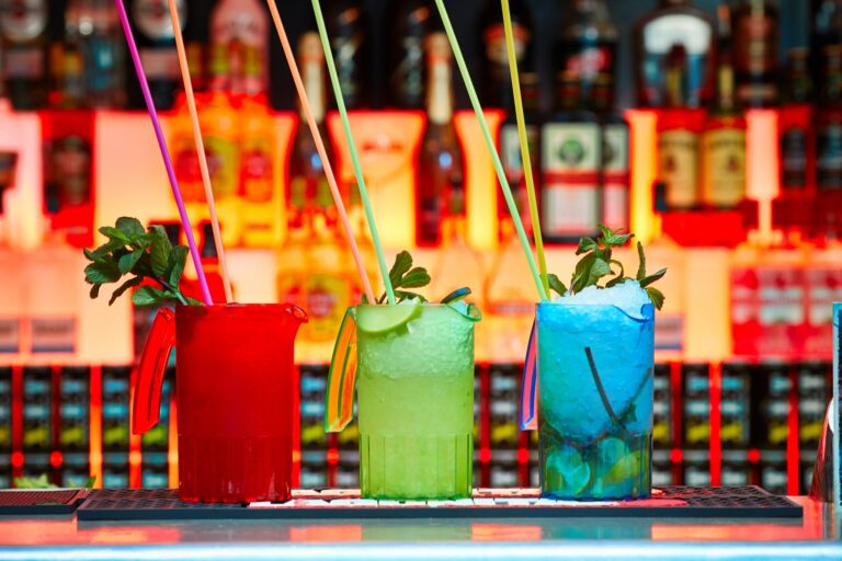 A zoomed in picture of three colourful cocktails