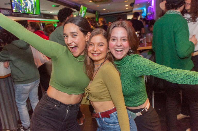 Three friends posing for the camera at a Belushi's bar