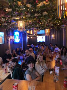 A picture of customers seated watching sports on HD screens at Belushi's bar