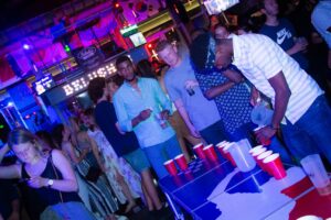 A group of customers playing beer pong at Belushi's bar