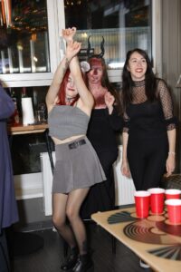 A few customers dressed up for Halloween at a Belushi's bar dancing and playing beer pong