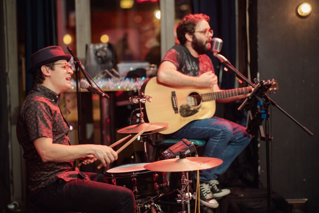 An image of two live musicians performing at a Belushi's bar