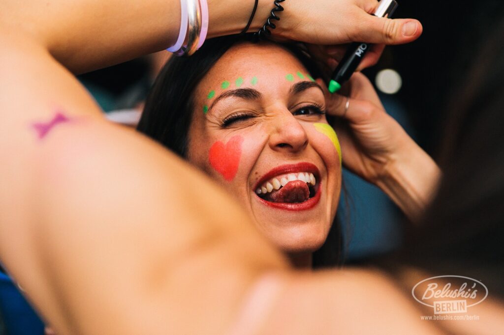 An image of a girl getting her face painted at a Belushi's bar