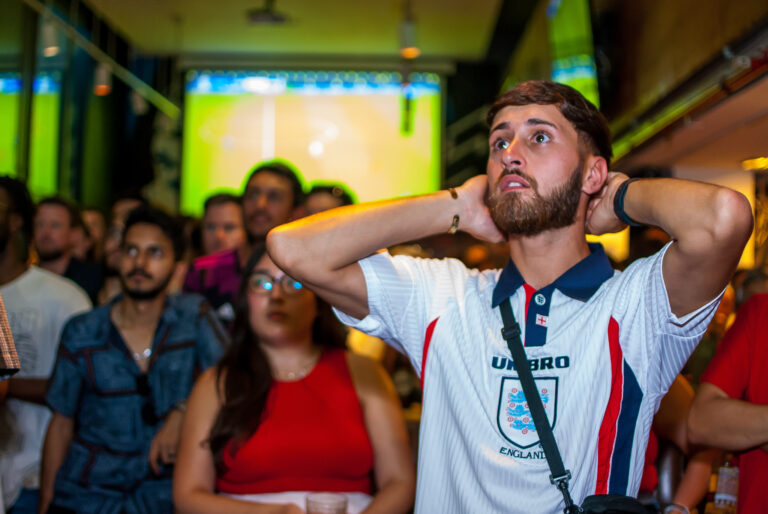 England football fan watching a game in anticipaton at a Belushi's bar