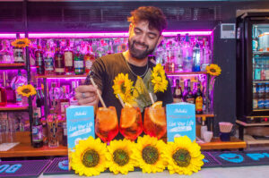 A bartender making an aperol spritz for Live your Life week at Belushi's