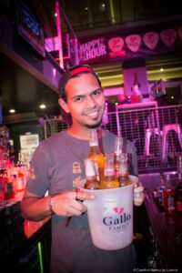 A picture of a smiling Belushi's customer with a bucket of beers