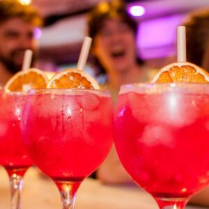 An image of three pink cocktails lined up at a Belushi's bar