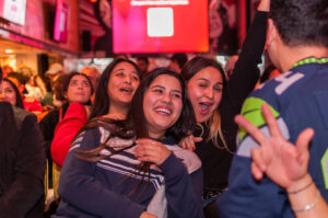 An image of three girls smiling for the camera at a Belushi's bar