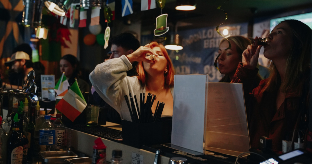 A group of customers enjoying shots at a Belushi's bar