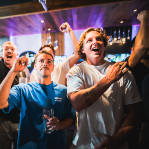 People watching football while drinking at a Belushi's bar