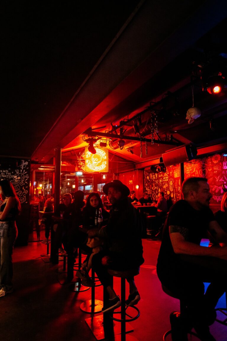 An image of a Belushi's bar lit with red lights