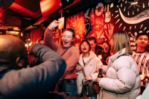 A group of friends dancing at a Belushi's bar