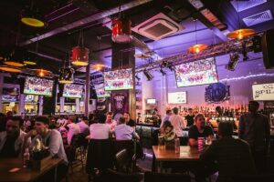 An interior view of a Belushi's bar, with customers seated, eating and drinking