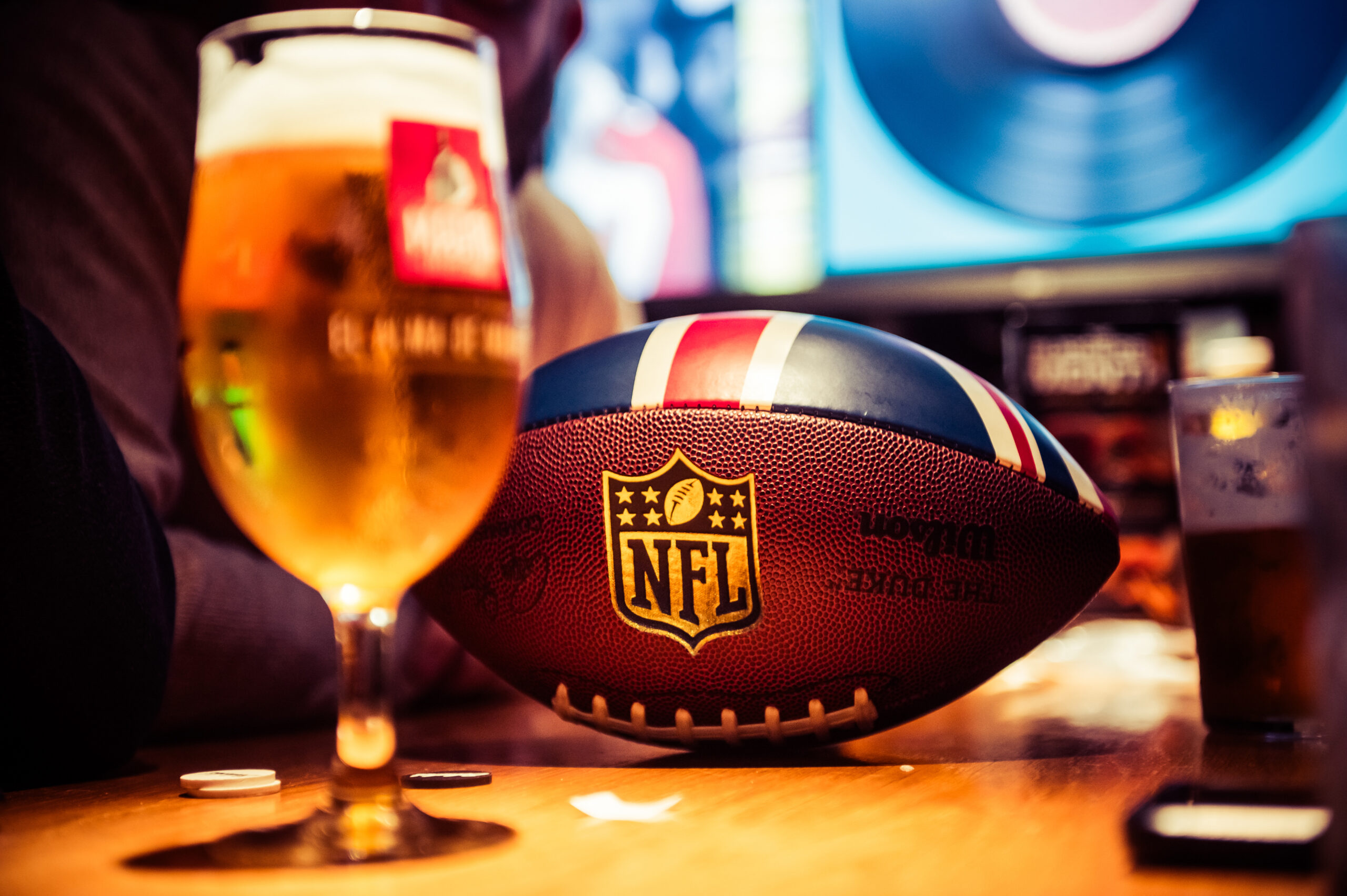 Super Bowl NFL Rugby Ball at Belushi's Sports bar with pint of beer